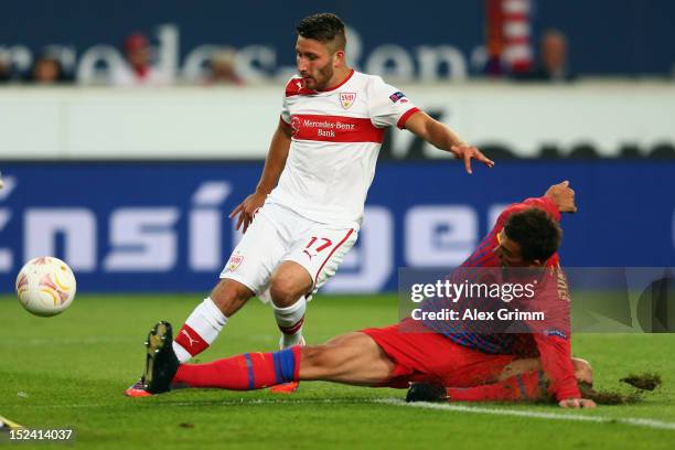 Tunay Torun of Stuttgart tries to score against Lukasz Szukala of Bucuresti during the UEFA Europa League group E match between VfB Stuttgart and FC...