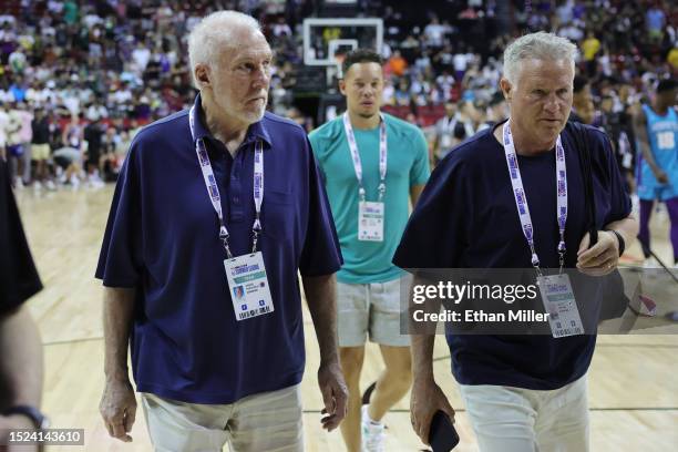 Head coach Gregg Popovich and assistant coach Brett Brown of the San Antonio Spurs leave the court following the victory against the Charlotte...