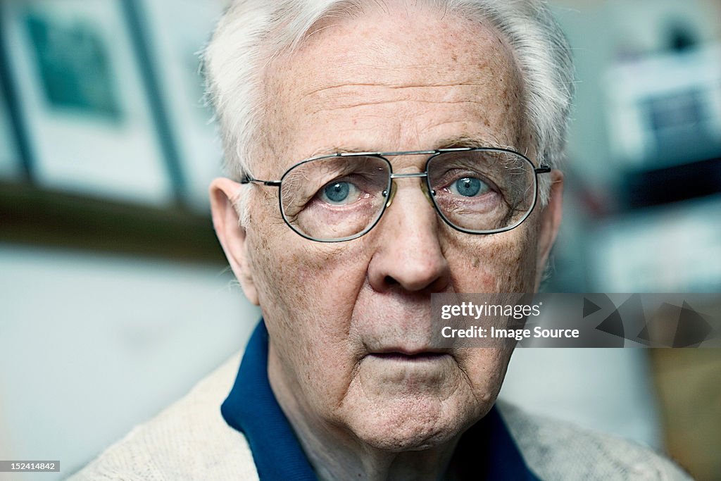 Close up portrait of a senior man looking confused