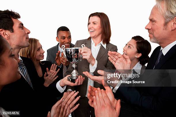 businesswoman receiving trophy, colleagues clapping - receiving award stock pictures, royalty-free photos & images