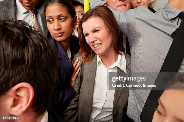 woman and man with sweaty armpit on crowded subway train - metro photos et images de collection