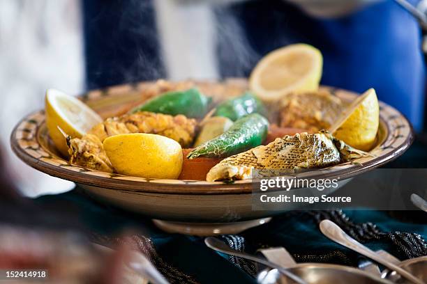 tunisian restaurant dish of grouper with vegetables, djerba - チュニジア文化 ストックフォトと画像