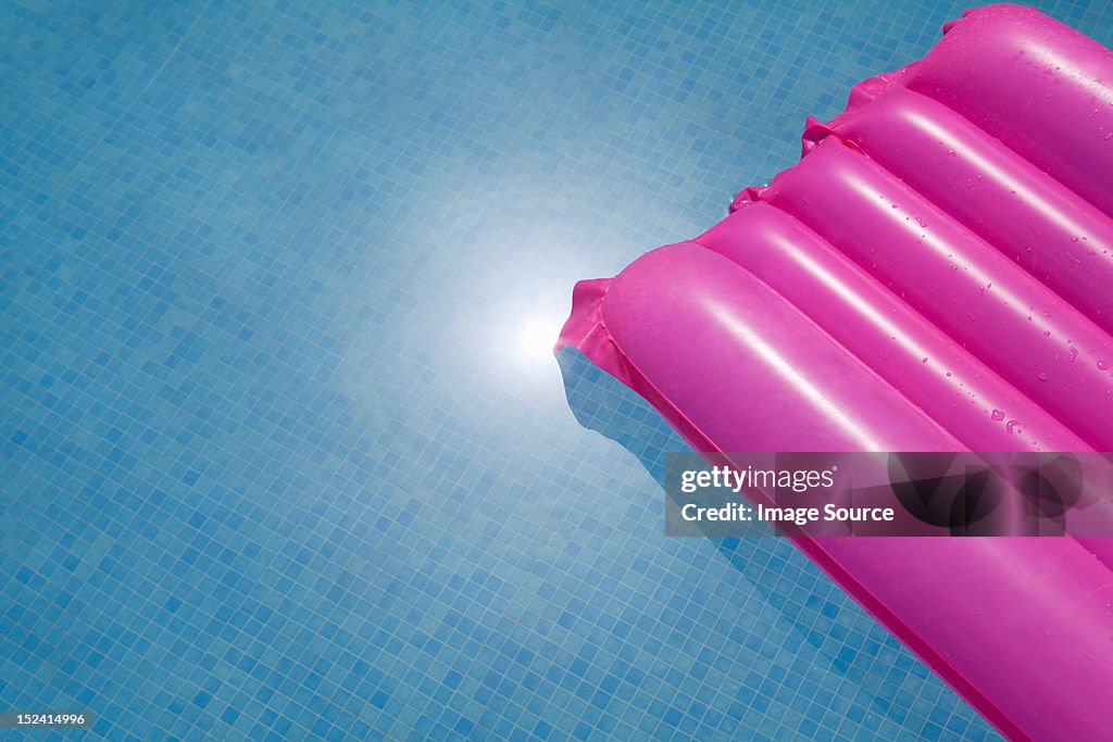 Pink inflatable in swimming pool
