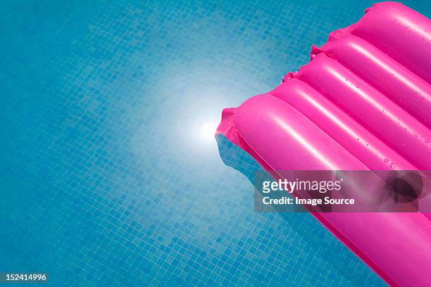 pink inflatable in swimming pool - lilo stock pictures, royalty-free photos & images