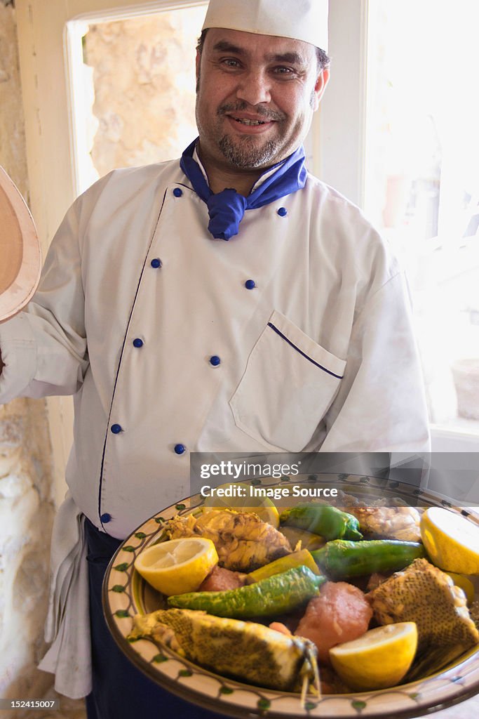 Chef with fish and vegetable dish in Djerba, Tunisia