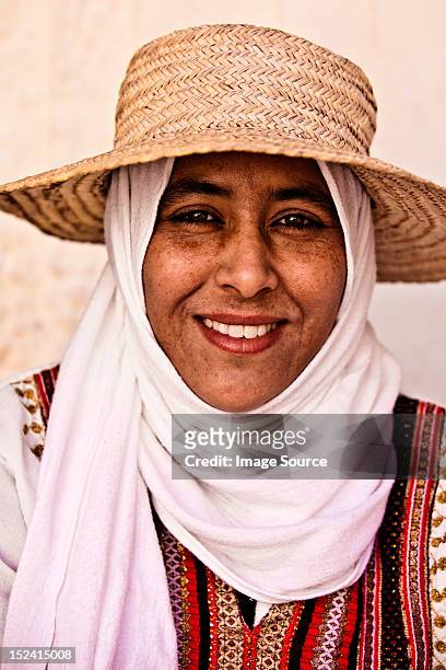 portrait of a young woman wearing hat and headscarf in djerba, tunisia - チュニジア文化 ストックフォトと画像