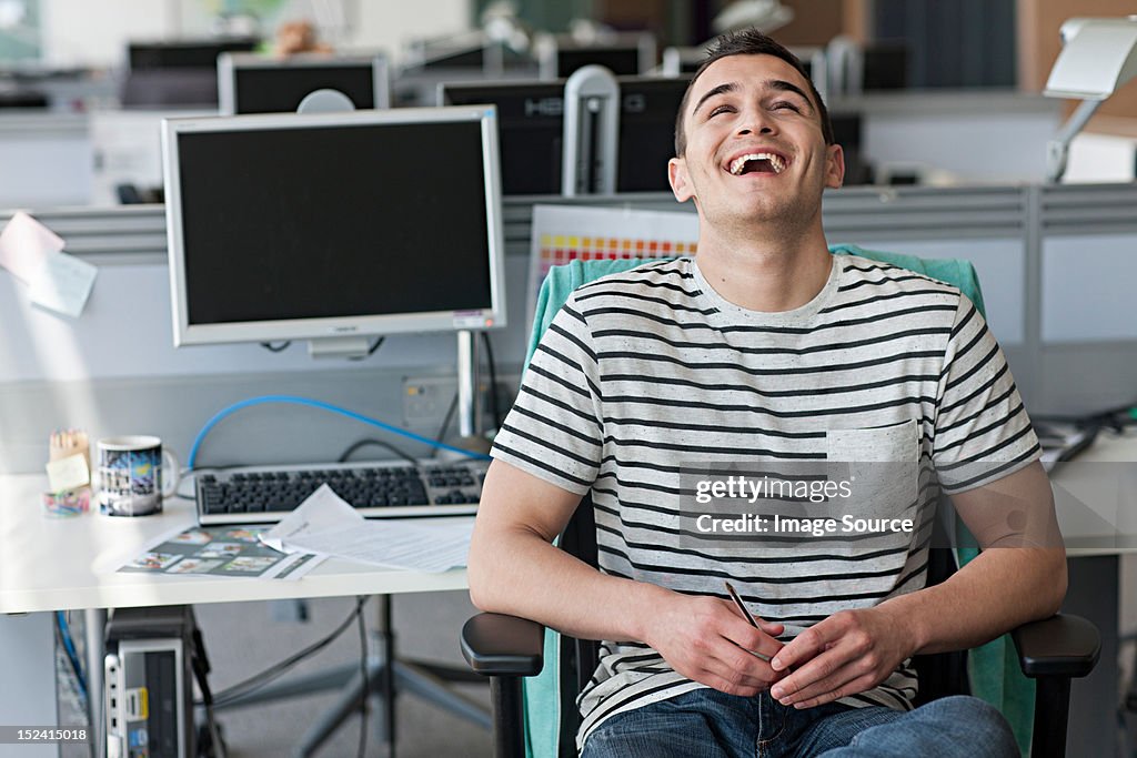 Man laughing in office