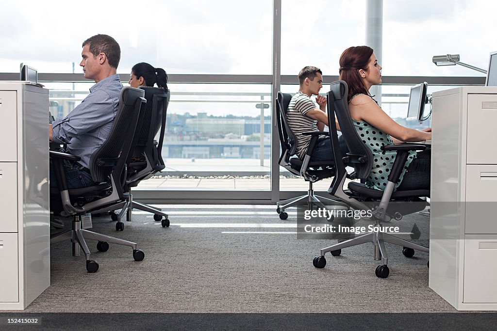 Creative business people at workstations