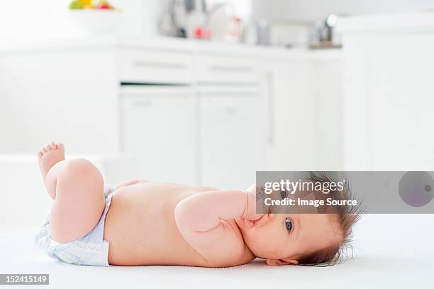 baby girl lying on back - baby sussex stock pictures, royalty-free photos & images