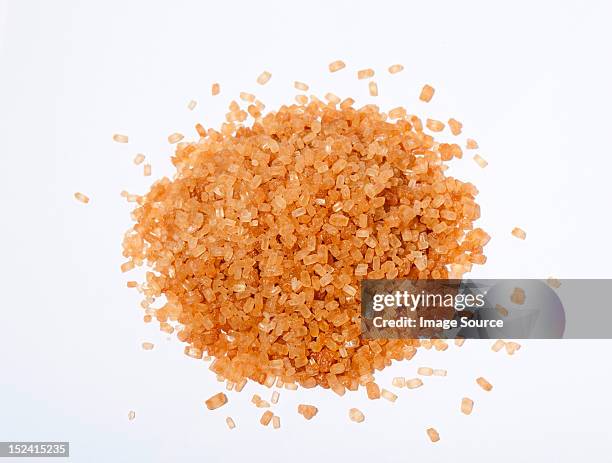 brown sugar crystals - sugar pile stock-fotos und bilder