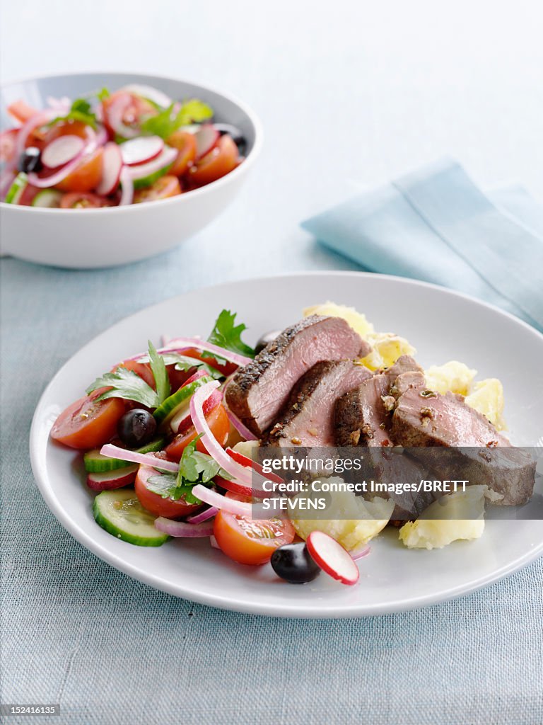 Plate of meat and vegetable salad