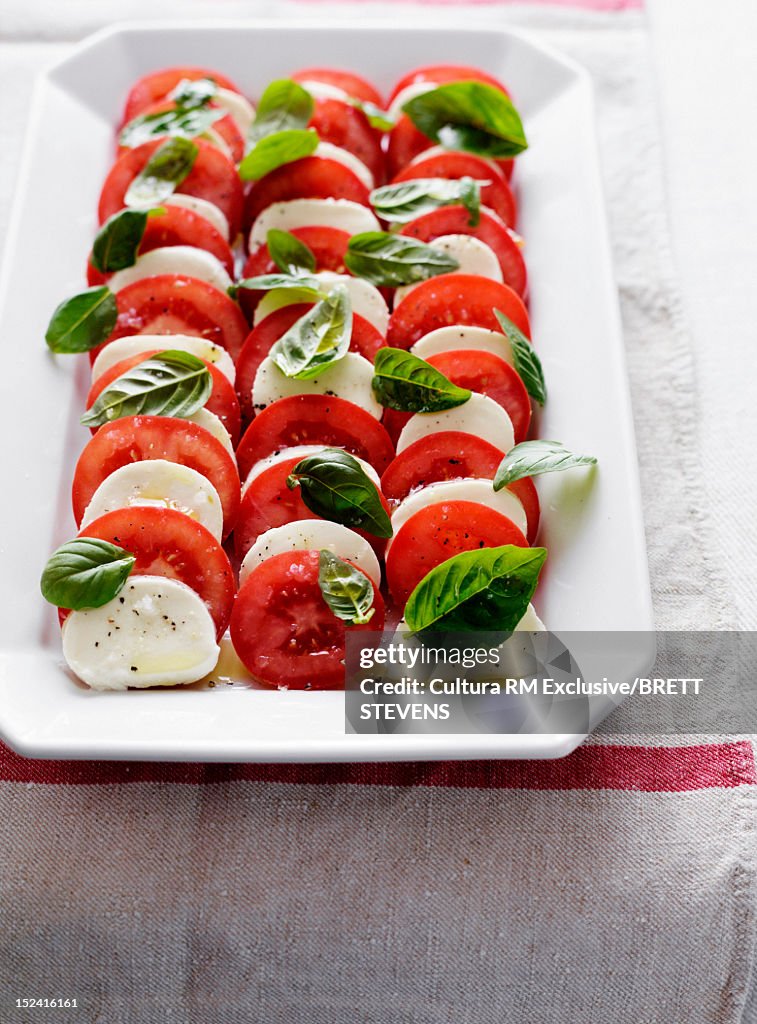 Plate of tomatoes, cheese and herbs