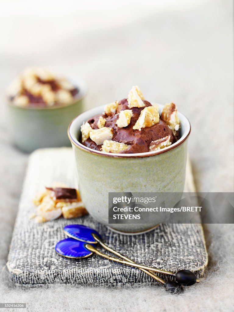 Cup of chocolate pudding with topping