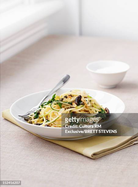 dish of pasta with vegetables - kalamata olive stock-fotos und bilder