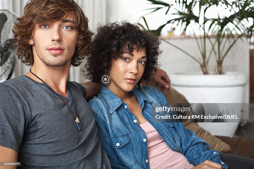Couple relaxing on sofa together