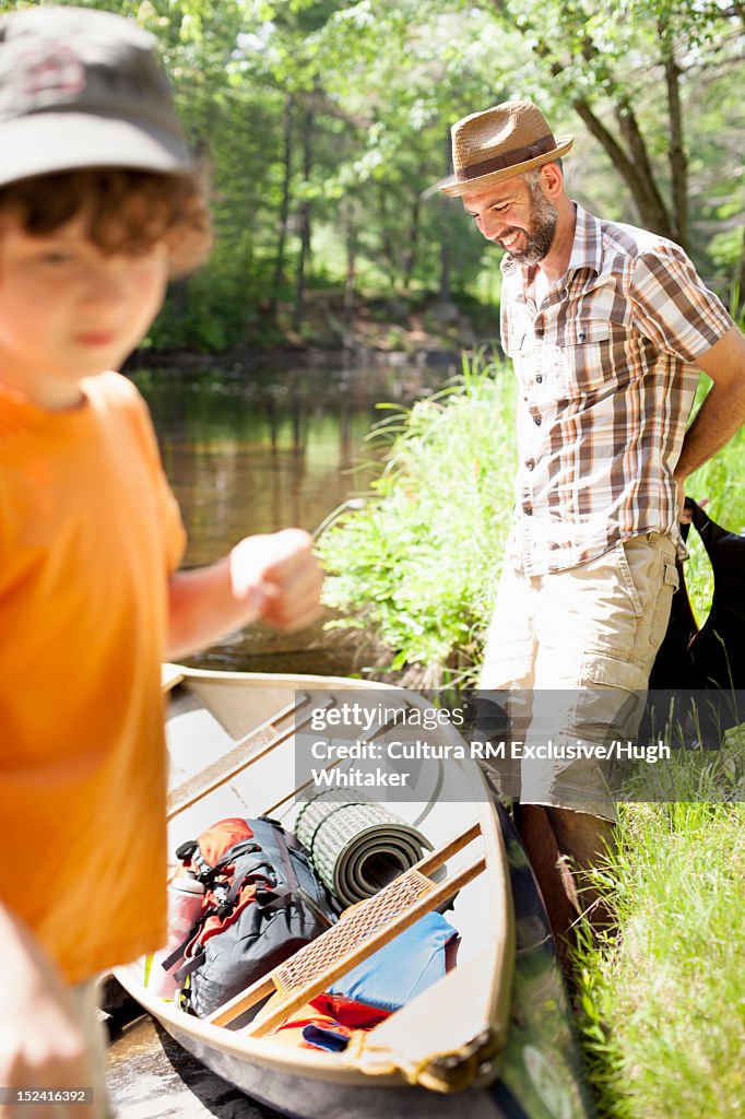 Father and son parking canoe on land