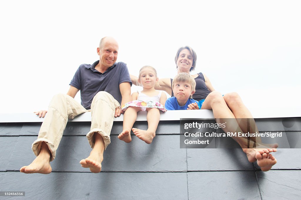 Family sitting on edge of wall