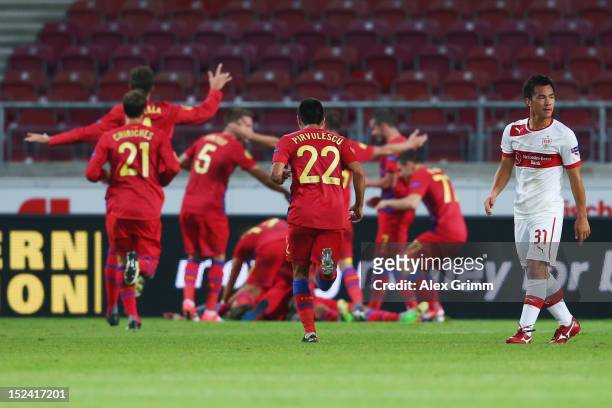 Shinji Okazaki of Stuttgart reacts as Raul Rusescu of Bucuresti celebrates his team's second goal with team mates during the UEFA Europa League group...