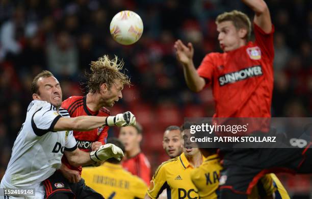Kharkiv´s goalkeeper Olexander Goryainov and Leverkusen's midfielder Simon Rolfes vie for the ball during the UEFA Europa League group K football...