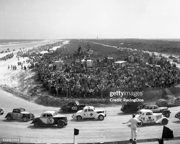 February 14, 1953: A huge crowd estimated at 10,000 people looks on as the field prepares for the start of the NASCAR Modified race on the Daytona...