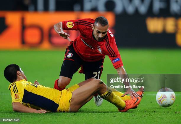 Oemer Toprak of Leverkusen is challenged by Jonathan Cristaldo of Kharkiv during the UEFA Europa League group K match between Bayer Leverkusen and FC...