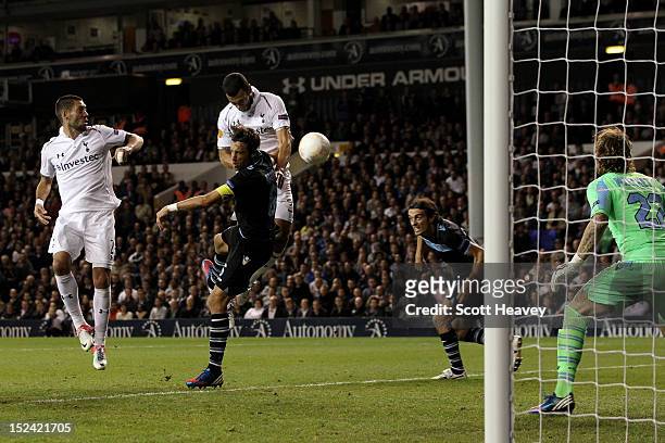 Steven Caulker of Spurs rises above Stefano Mauri of Lazio to put the ball in the net, only for the goal to be disallowed by Referee Ovidiu Alin...