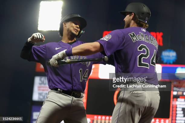 Ezequiel Tovar of the Colorado Rockies celebrates with Ryan McMahon after hitting a three-run home run in the top of the seventh inning against the...