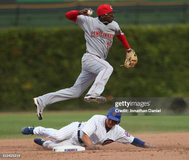 Darwin Barney of the Chicago Cubs forces Didi Gregorius of the Cincinnati Reds into missing a double play throw at Wrigley Field on September 20,...