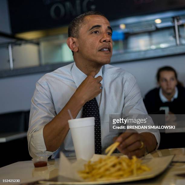 President Barack Obama meets with supporters about voter registration at OMG Burgers on September 20, 2012 in Miami, Florida. Obama is traveling in...