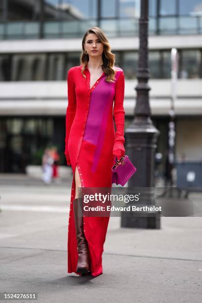 Zita D'Hauteville wears a gold cut-out pattern logo earring from Fendi, a neon red and neon purple bicolored pleated long sleeves / asymmetric...