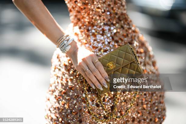 Heart Evangelista wears a beige brown with embroidered brown / green / silver sequined shoulder-off / puffy short dress, diamonds large rings, white...