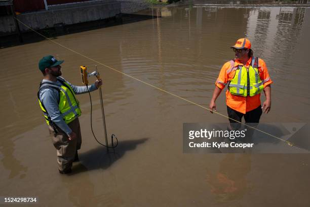 Geological Survey hydrographers Samuel Jacob, left, and Jeff Rowan measure the flooded Winooski River's discharge on July 11, 2023 in Montpelier,...