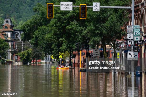 People kayak down Main Street after catastrophic flooding on July 11, 2023 in Montpelier, Vermont. Up to eight inches of rain fell over 48 hours and...