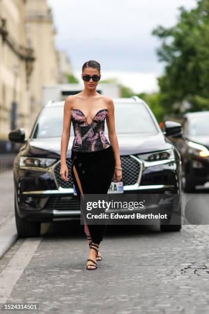 Gabrielle Caunesil wears black sunglasses, a black and beige tie and dye silk pattern / embroidered black and pink pearls pattern / heart-neck...