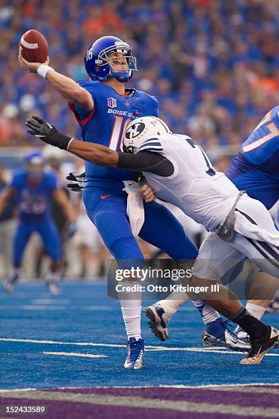 Joe Southwick of the Boise State Broncos throws just ahead of a hit by Preston Hadley of the BYU Cougars at Bronco Stadium on September 20, 2012 in...