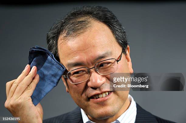 Takashi Tanaka, president of KDDI Corp., attends a launch event for the Apple Inc. IPhone 5 in Tokyo, Japan, on Friday, September. 21, 2012. Apple is...