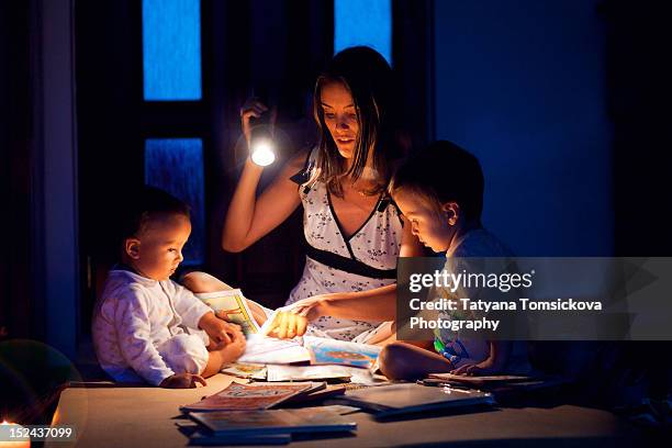 mother with her two son - flashlight stock pictures, royalty-free photos & images