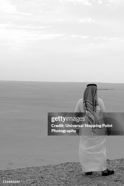 saudi man looks out on desert - dammam stock pictures, royalty-free photos & images