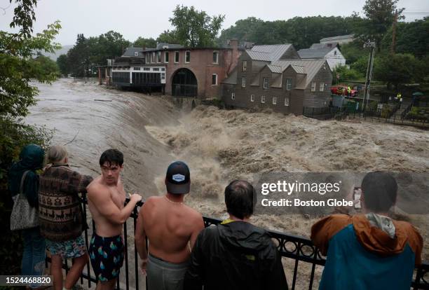 Quechee, VT People line the railing over the Ottauquechee River to get a closer look as the river rises.