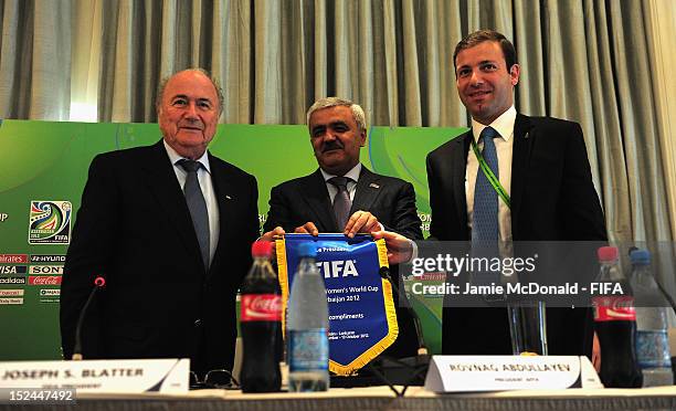 President Joseph S. Blatter gives a pennant to Rovnag Abdullayev during a FIFA U-17 Women's World Cup 2012 press conference at the Four Seasons Hotel...