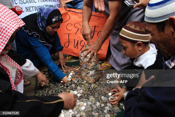 Philippine Muslims collect money to be used to file law suits against showing the anti-Islam film during a gathering in Marawi City, Lanao del sur,...