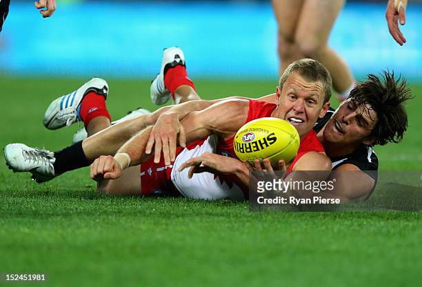 Ryan O'Keefe of the Swans is tackled by Scott Pendlebury of the Magpies during the second AFL Preliminary Final match between the Sydney Swans and...