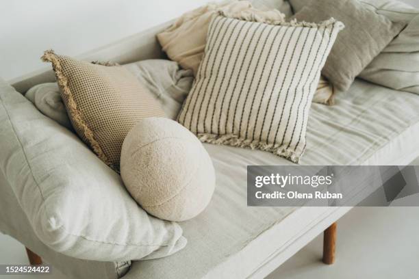 gray couch with heap of cushions. - shabby chic stockfoto's en -beelden