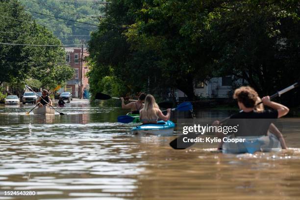 People kayak up and down the flooded waters of Elm Street on July 11, 2023 in Montpelier, Vermont. Up to eight inches of rain fell over 48 hours and...