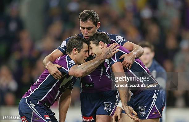 Cameron Smith and Cooper Cronk congratulate Billy Slater of the Storm after he scored a try in the second half during the NRL Preliminary Final match...