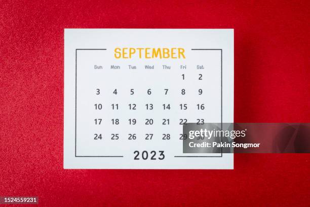 calendar desk 2023: september is the month for the organizer to plan and deadline with a red paper background. - september stock pictures, royalty-free photos & images