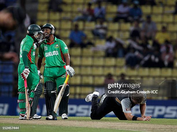 Mohammad Ashraful and Mushfiqur Rahim of Bangladesh laugh as Jacob Oram of New Zealand lays on the ground during the ICC World T20 Group D match...