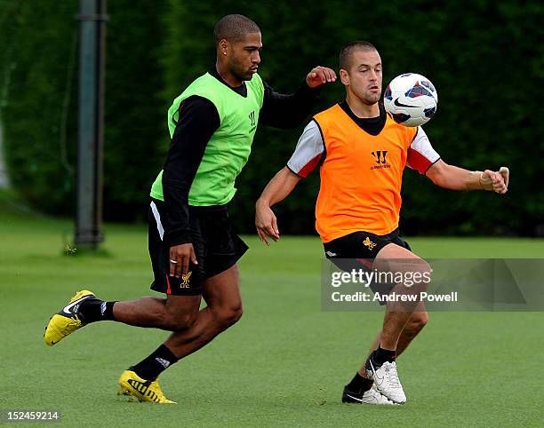 Glen Johnson and Joe Cole of Liverpool compete for the ball during a training session at Melwood Training Ground on September 21, 2012 in Liverpool,...