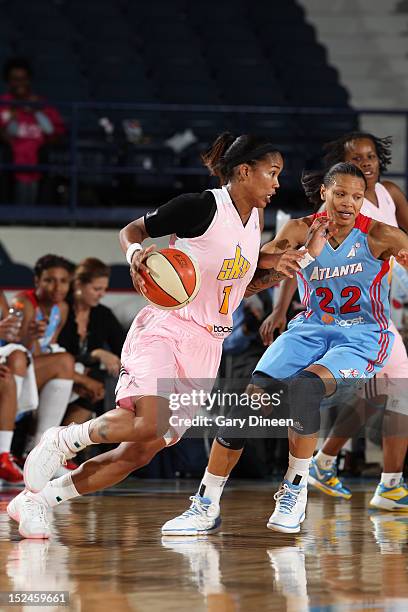 Tamera Young of the Chicago Sky moves the ball past Arminte Price of the Atlanta Dream on September 20, 2012 at the Allstate Arena in Rosemont,...