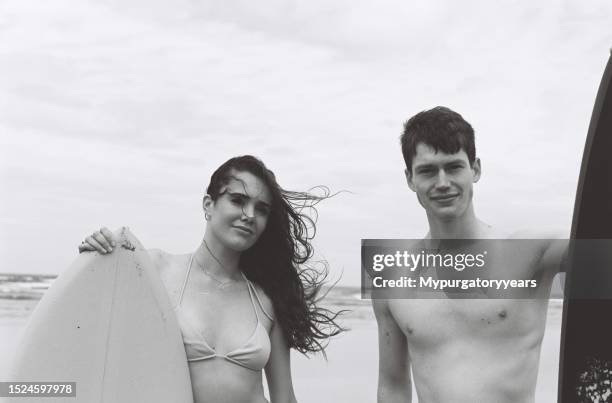 surfers on the beach - rip curl stock pictures, royalty-free photos & images